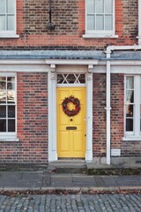 Fototapeta na wymiar Brick house with a yellow door