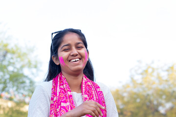 Young smart indian girl face coloured with gulal 