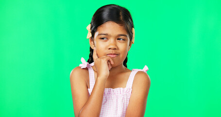 Thinking, green screen and idea by child with a question feeling excited, thoughtful and isolated in studio background. Planning, girl and joyful kid is happy, curious and planning expression