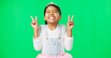 Peace, fun and hand gesture with a girl on a green screen background in studio feeling silly or carefree. Portrait, dance and emoji with an adorable little female child looking goofy or playful