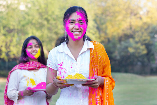 Young Indian Women Holding Powder Colours In Plate On The Festival Of Colours Called Holi