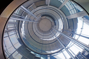 Futuristic uprisen angle view from the bottom to the top of spiral staircase