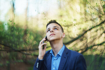 photo boy with a mobile phone in various poses, the concept of modern life