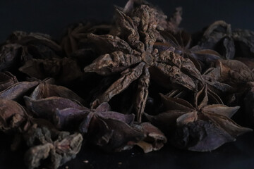 Star anise with low light and black background