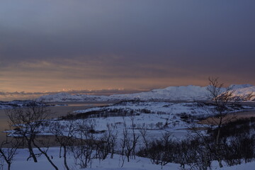 snowy nature landscape at sunset in tromso, norway