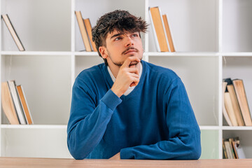 Fototapeta premium portrait of young student at desk pensive