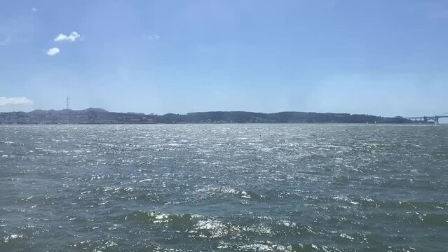 The Golden Gate Bridge and San Francisco skyline, featuring Sutro Tower, as seen from the San Francisco Bay on a beautiful, sunny day.
