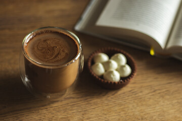 Coffee cup with book and cake. Still life with coffee. Morning drinks. Coffee break. Cacao cup with open book. Espresso with sweet dessert. Delicious breakfast. Hot drinks. Reading book with coffee.