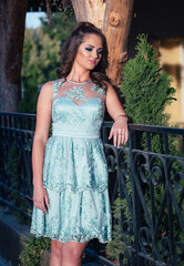 Portrait of young, teen girl in blue lace dress, ready for her prom night