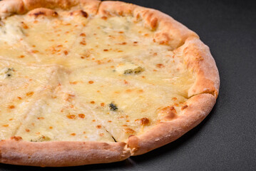 Delicious fresh hot pizza four cheeses cut into pieces