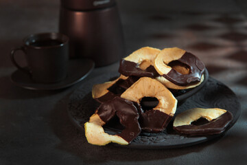 Apple dried fruits in chocolate.Vertical photo.Healthy food. Dessert without sugar.