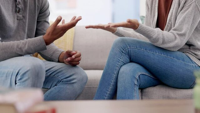 Couple, hands and argument in disagreement on sofa in living room dispute or confession at home. Hand of frustrated woman and man in communication for breakup, affair or fight in conflict or divorce