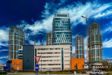 Bratislava city skyline, modern industrial buildings, and new high-rising apartments in Slovakia, with dramatic clouds