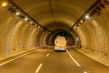 Tank truck for the transport of fuels circulating inside a tunnel, rear view.
