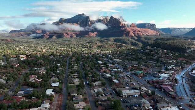 Aerial view of the mountains in Sedona, AZ covered with white clouds.