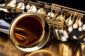 Fototapeta na wymiar closeup details of black golden alto saxophone musical instrument metal dark background. brass jazz music concept.