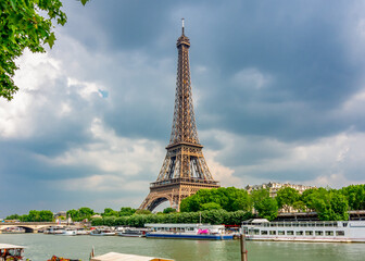 Fototapeta na wymiar Eiffel Tower and boats along Seine river, Paris, France