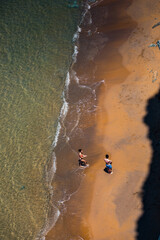 Corfu, Grece - July 10, 2020 - Sunbathers at Logas Beach seen from the top of the cliff