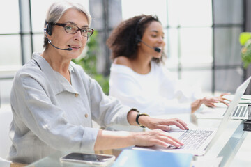 Fototapeta premium operator woman agent with headsets working in a call centre.