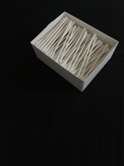 Box of recyclable ear cotton swabs on black background