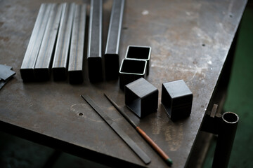 Deburring the cut square pipe with a file
