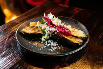 Baked vegetables, vegan dish on wooden table