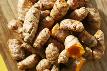 detail shot of turmeric root in bowl on table ,