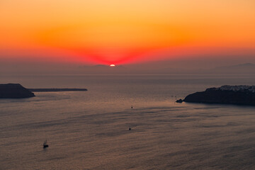 Santorini, Grece - July 23, 2020 -  Amazing red sunset over Oia and caldera of the Santorini island, Greece