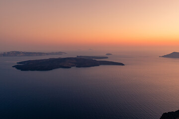 Santorini, Grece - July 23, 2020 -  Amazing red sunset over Oia and caldera of the Santorini island, Greece