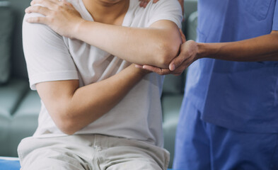 Fototapeta premium Patient doing some special exercises under supervision in a room