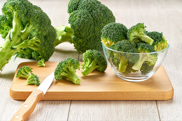 fresh raw broccoli on a cutting board, healthy food preparation.