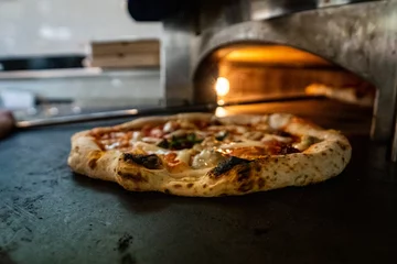 Tuinposter Pizza Napoletana Italian Pizza in the making by cook  © Mateusz