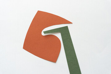 cut brown paper shape with distinct wavy form and green paper shape