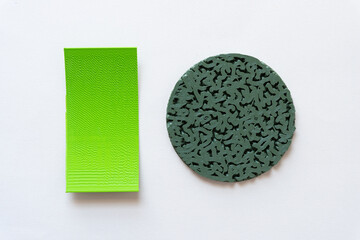 3d printed objects (green panel and circle with infill texture)