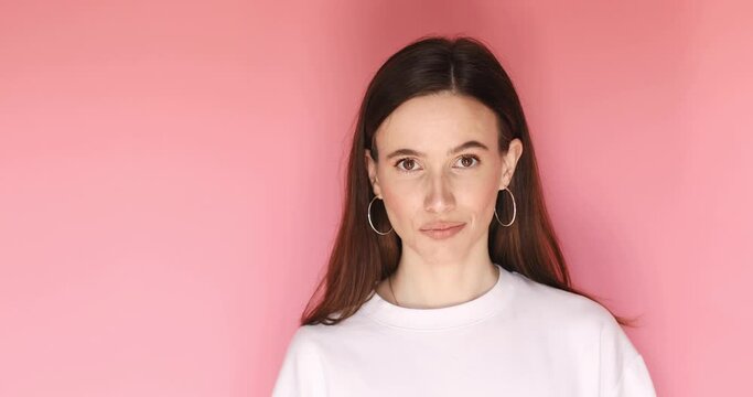 You suck, loser gesture. Dissatisfied and disappointed, skeptical adult female, shows thumb finger down, girl does not like something, gossips about people are bad disgusting, show tongue on pink.