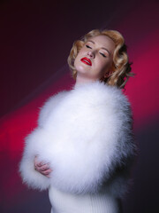 Blonde with short hairstyle wavy hair and red lipstick in light clothes with goose down retro look 50-60 years