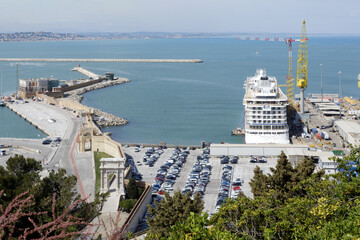 Traghetto o nave in partenza in porto fra il parcheggio e il cantiere navale