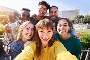 Group of happy friends posing for a selfie on a spring day as they party together outdoors. Group of multicultural friends having a good time together on the weekend. - obrazy, fototapety, plakaty