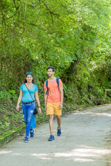 Obraz premium mixed race couple trekking in senda del oso, Asturias. Mid adult ecotourism in Proaza