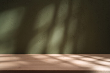 Empty table on khaki green texture wall background. Composition with abstract shadow on the wall...