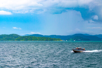 Fototapeta na wymiar Travel Thailand by ferry boat yacht waves through tropical landscape.