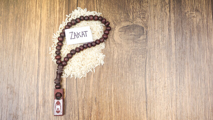 Islamic zakat concept. Selective focus image rice with prayer beads.