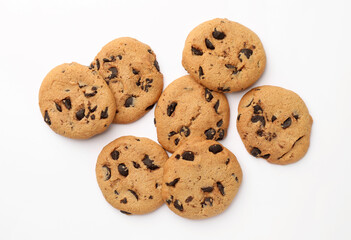 Many delicious chocolate chip cookies on white background, flat lay