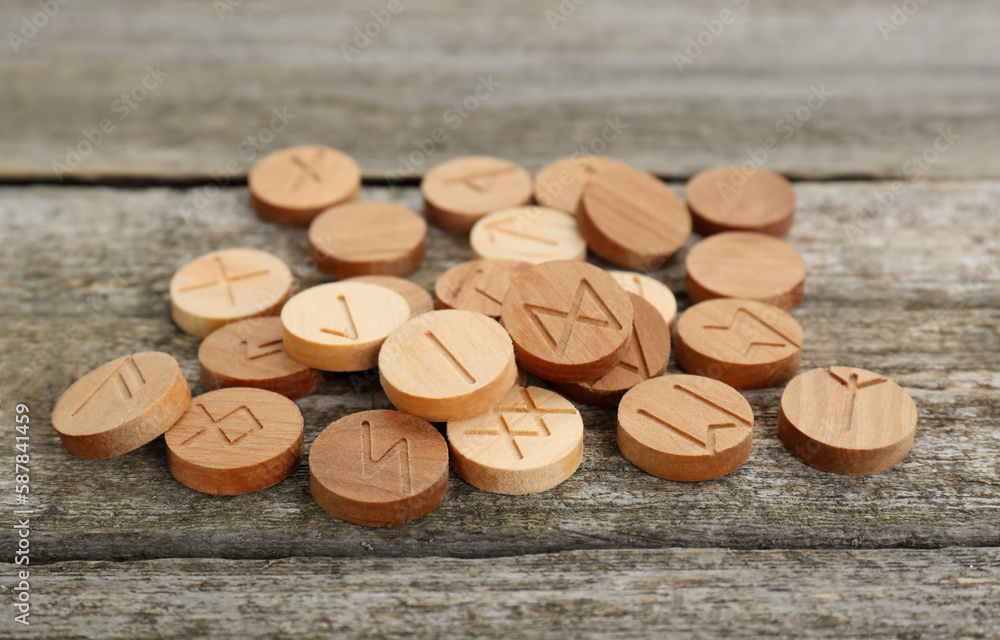 Wall mural pile of runes with different symbols on wooden table