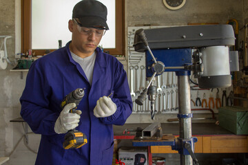 Image of a blacksmith in his workshop changing the broken bit of a drill. Reference to the poor quality of some tools.
