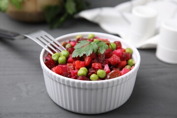Delicious vinaigrette salad on grey wooden table, closeup