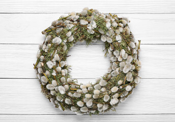 Wreath made of beautiful willow flowers on white wooden table, top view © New Africa