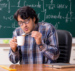 Funny male math teacher in the classroom