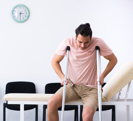 Young injured man waiting for his turn in hospital hall