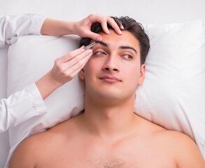 Naklejka premium Handsome man in spa massage concept
